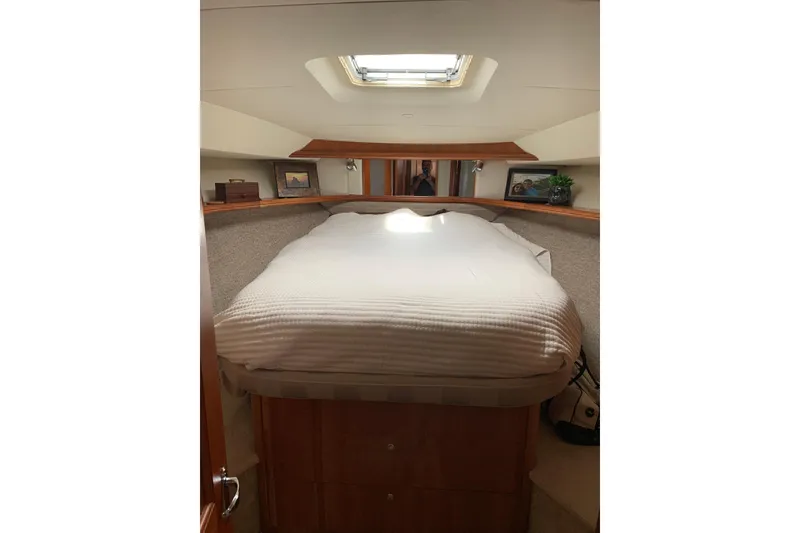 Slide: The Image of Cozy cabin interior of 2002 Silverton 42 Convertible yacht with skylight and bed. - 9