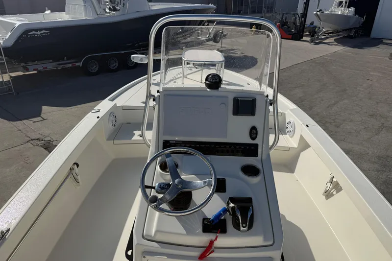 Slide: The Image of 2021 Pathfinder 2500 Hybrid boat interior with steering console and navigation equipment. - 12