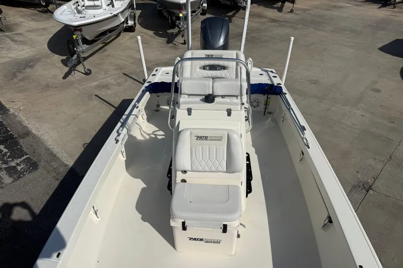 Slide: The Image of 2021 Pathfinder 2500 Hybrid boat, white interior, parked on concrete lot. - 13