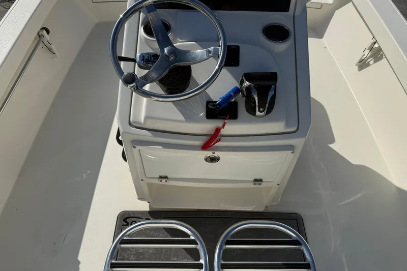 Slide: The Image of 2021 Pathfinder 2500 Hybrid boat console with steering wheel and controls. - 17