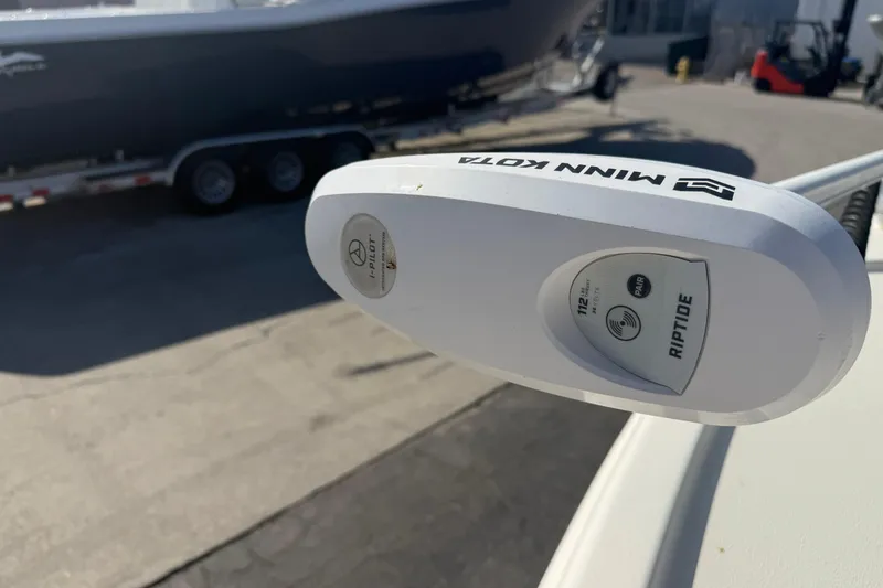Slide: The Image of Minn Kota Riptide motor on 2021 Pathfinder 2500 Hybrid boat, trailer in background. - 18