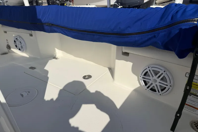 Slide: The Image of Interior of 2021 Pathfinder 2500 Hybrid boat with blue cover and speakers. - 20