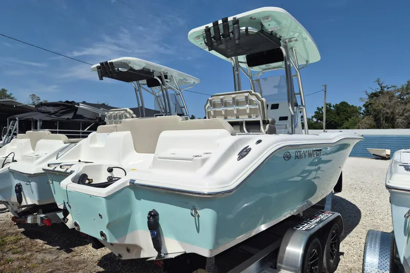 The Image of 2026 Key West 239 FS boat with dual consoles and T-top, parked on a trailer. - 1