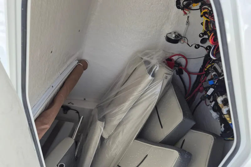 Slide: The Image of Interior view of 2026 Key West 239 FS boat showing wiring and storage area. - 12