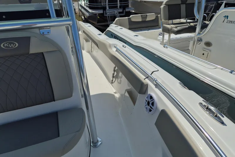 Slide: The Image of 2026 Key West 239 FS boat interior with seating and speaker detail. - 16