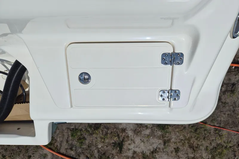 Slide: The Image of 2026 Key West 239 FS boat compartment with secure latch and hinges. - 21