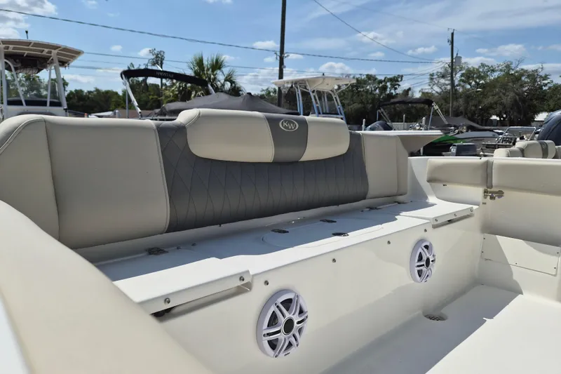 Slide: The Image of 2026 Key West 239 FS boat interior with cushioned seating and built-in speakers. - 4
