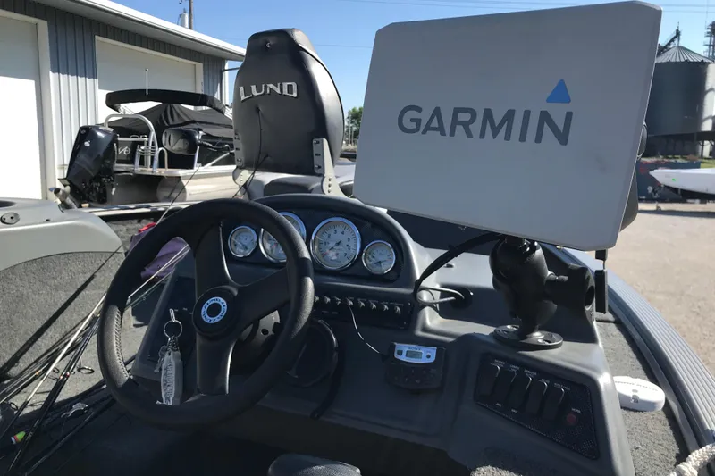 Slide: The Image of 2011 Lund 1775 Impact boat dashboard with Garmin GPS and steering wheel. - 12