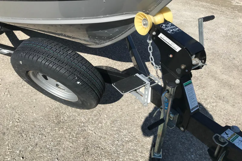 Slide: The Image of Trailer hitch and tire of 2011 Lund 1775 Impact boat on gravel surface. - 18