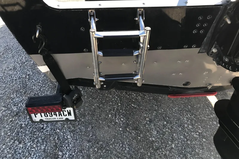 Slide: The Image of Rear view of 2011 Lund 1775 Impact boat with ladder and trailer license plate. - 21