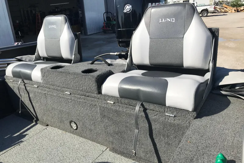 Slide: The Image of 2011 Lund 1775 Impact boat seats with gray upholstery and storage compartment. - 22