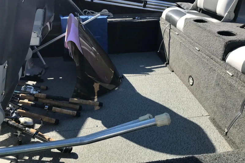 Slide: The Image of Interior of a 2011 Lund 1775 Impact boat with fishing rods and equipment. - 24