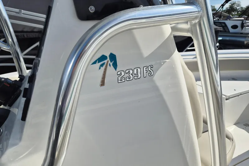Slide: The Image of 2026 Key West 239 FS boat detail with palm tree logo and stainless steel railing. - 12
