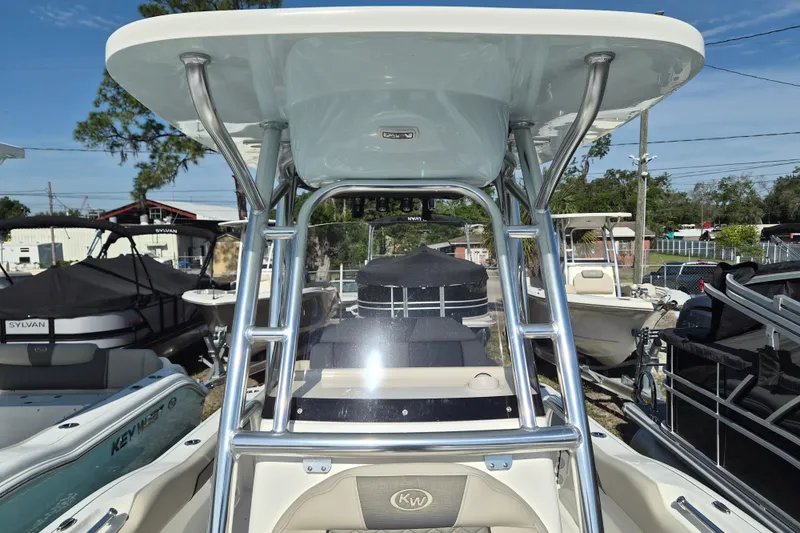 Slide: The Image of 2026 Key West 239 FS boat with T-top and sleek design in a marina setting. - 17