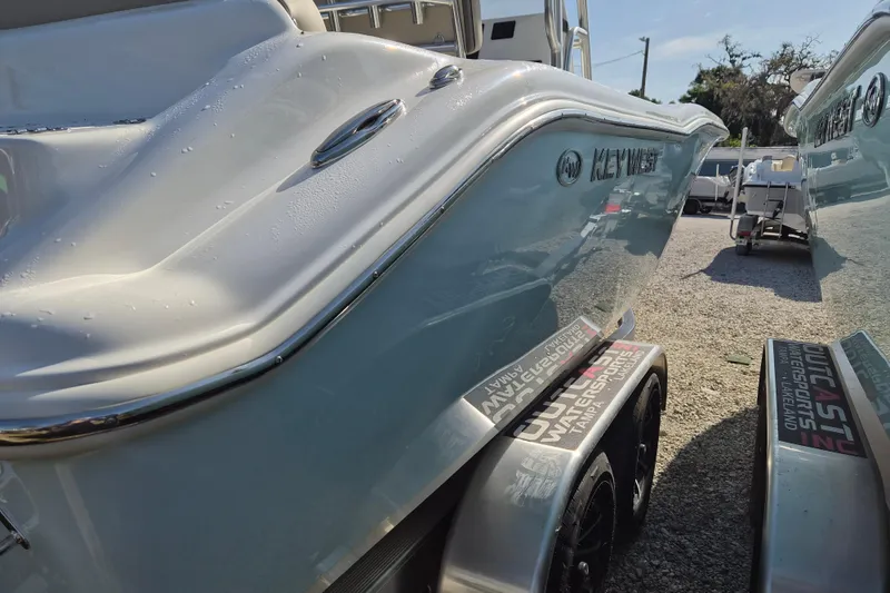 Slide: The Image of 2026 Key West 239 FS boat on trailer, side view with sunlight reflections. - 22