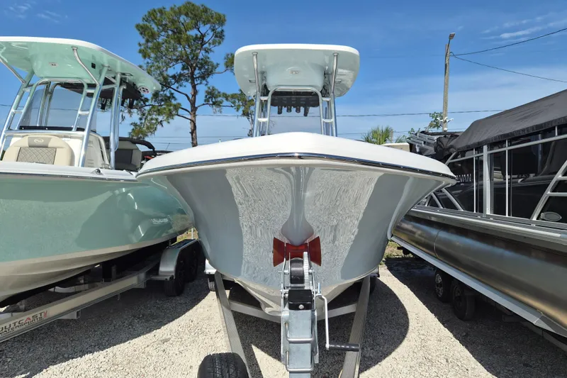 Slide: The Image of 2026 Key West 239 FS boat on trailer, parked outdoors under clear sky. - 23