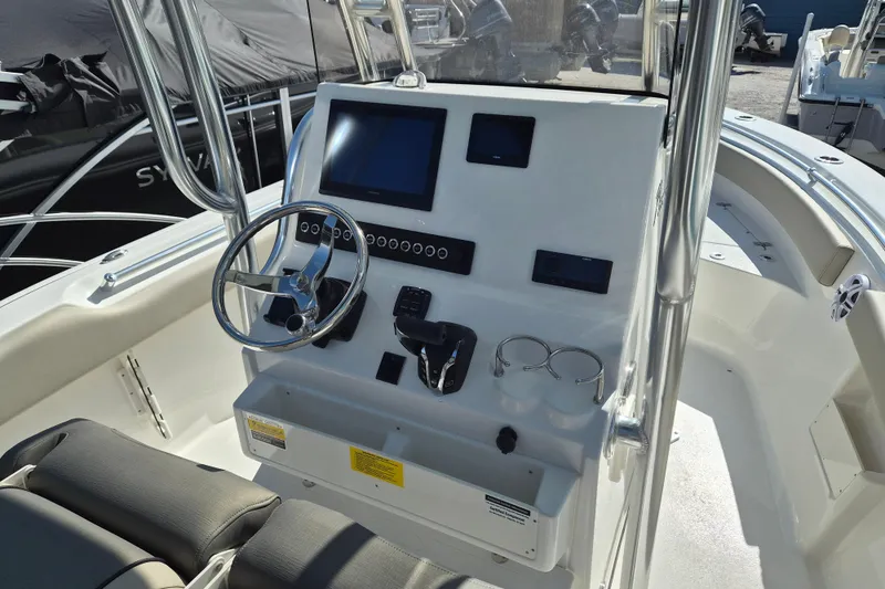 Slide: The Image of 2026 Key West 239 FS boat dashboard with steering wheel and electronic controls. - 8