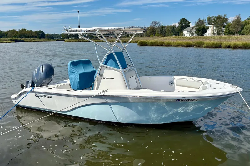 The Image of 2021 Sea Fox 206 Commander boat on calm water, featuring a sleek design and blue accents. - 0