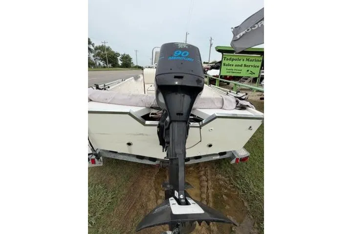 Slide: The Image of 2003 Kenner 18-V boat with 90 Mercury outboard motor, parked on a trailer. - 3