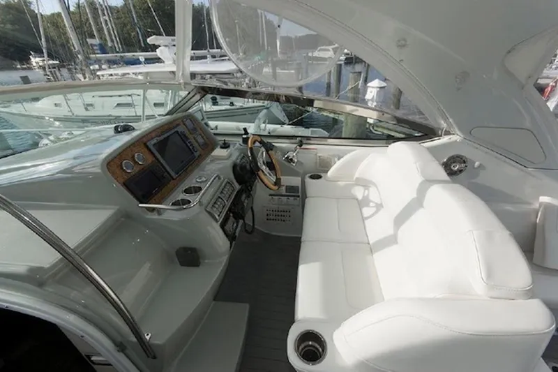 Slide: The Image of Interior of a 2011 Formula 37 Performance Cruiser with white seating and control panel. - 15