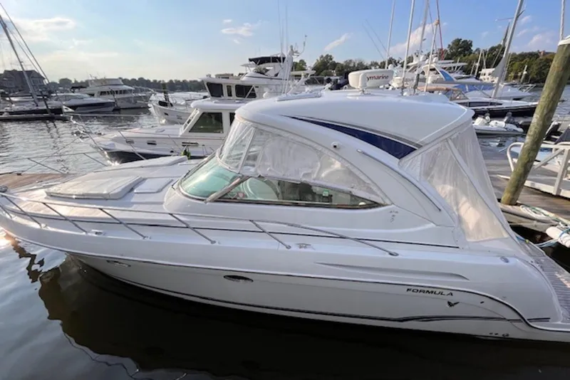 Slide: The Image of 2011 Formula 37 Performance Cruiser docked at a marina, surrounded by other boats. - 3