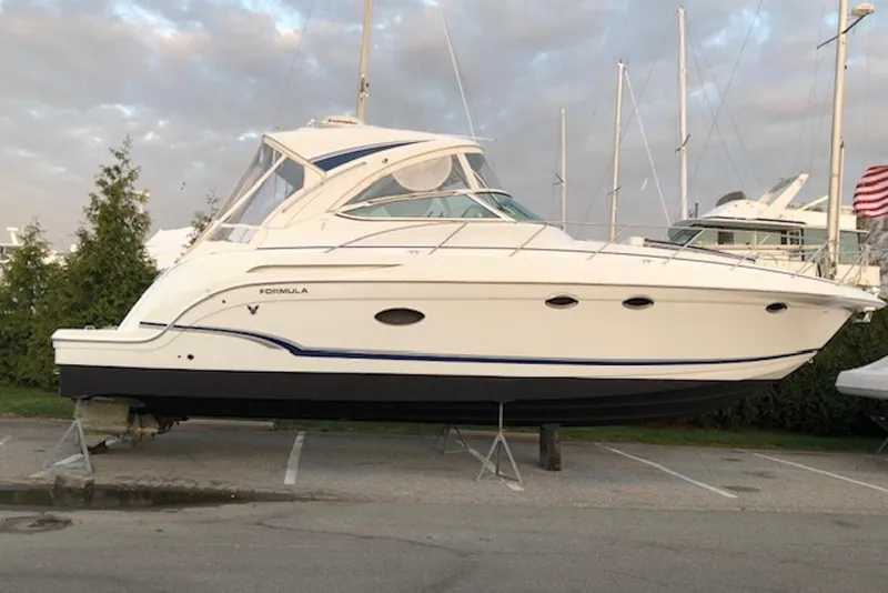 Slide: The Image of 2011 Formula 37 Performance Cruiser yacht on stands, parked outdoors. - 32