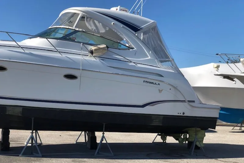 Slide: The Image of 2011 Formula 37 Performance Cruiser on stands, side view, clear sky background. - 33