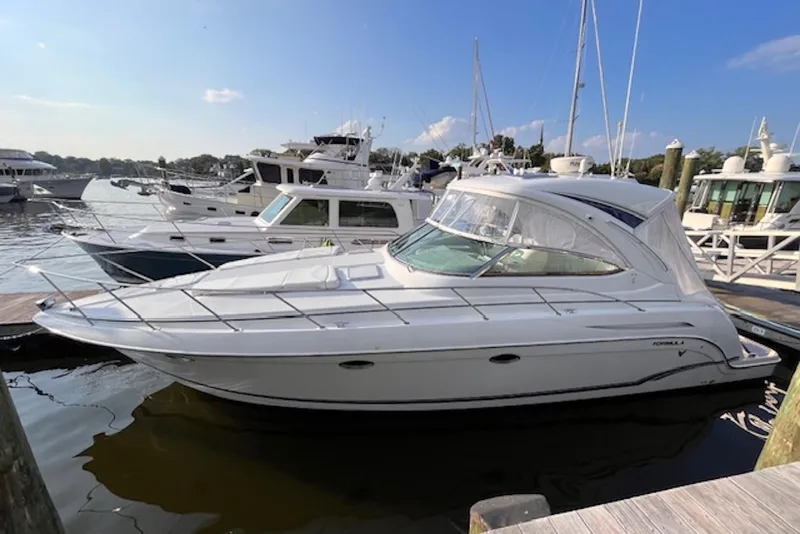 Slide: The Image of 2011 Formula 37 Performance Cruiser docked at marina under clear blue sky. - 5