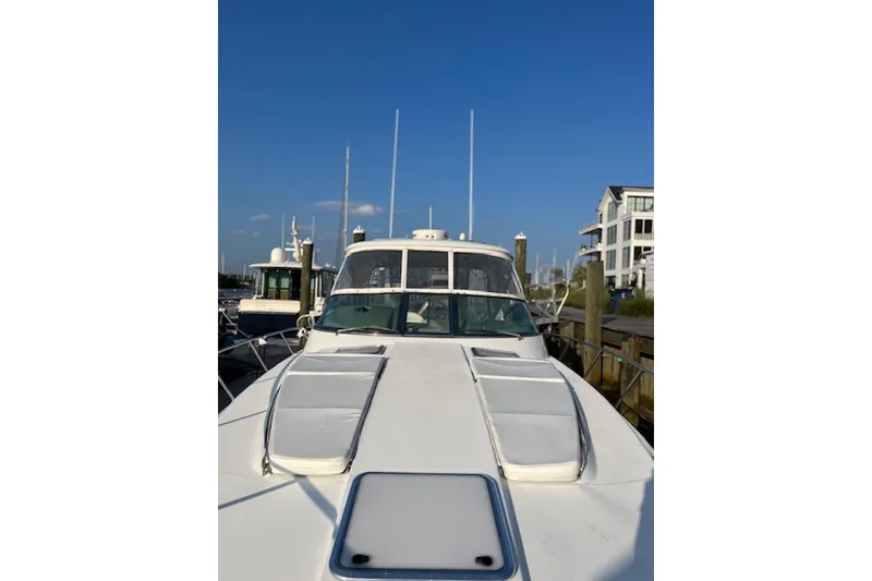 Slide: The Image of 2011 Formula 37 Performance Cruiser docked at marina under clear blue sky. - 8