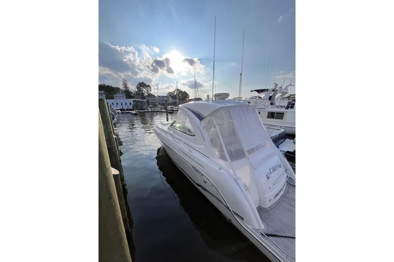 Slide: The Image of 2011 Formula 37 Performance Cruiser docked at marina under a bright sky. - 9
