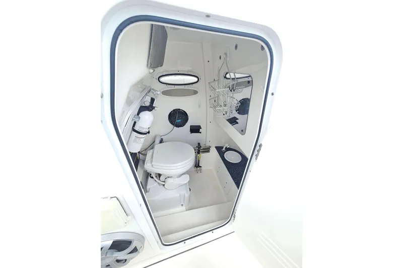 Slide: The Image of Interior view of 2021 Sea Pro 259 Center Console boat's compact bathroom. - 13