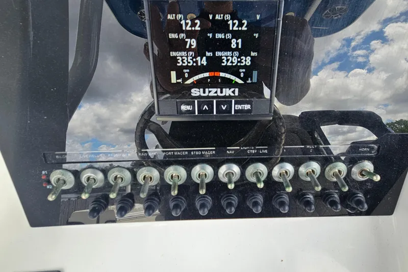 Slide: The Image of Control panel of a 2021 Sea Pro 259 Center Console boat with Suzuki display. - 16