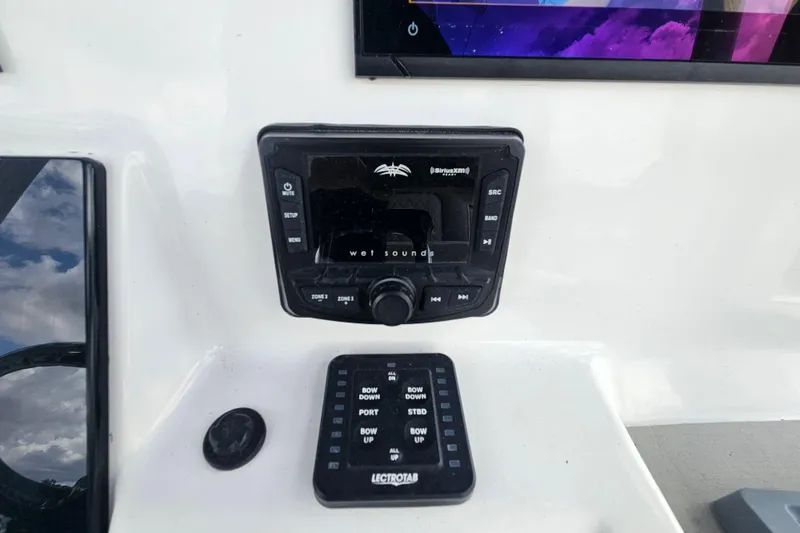 Slide: The Image of 2021 Sea Pro 259 Center Console dashboard with audio controls and Lectrotab panel. - 17