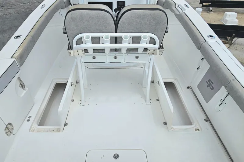 Slide: The Image of 2021 Sea Pro 259 Center Console boat interior with seating and storage compartments. - 21
