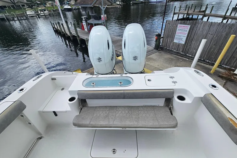 Slide: The Image of 2021 Sea Pro 259 Center Console boat with dual engines at a dockside location. - 22