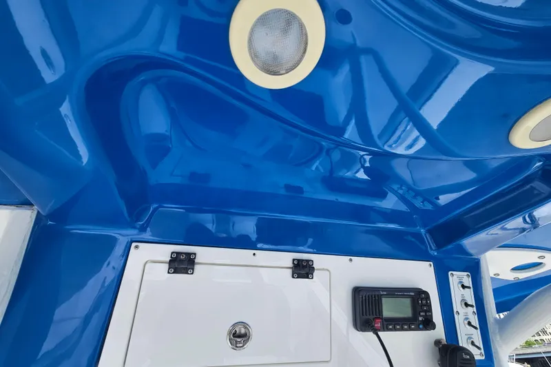 Slide: The Image of 2021 Sea Pro 259 Center Console boat interior with blue ceiling and control panel. - 23