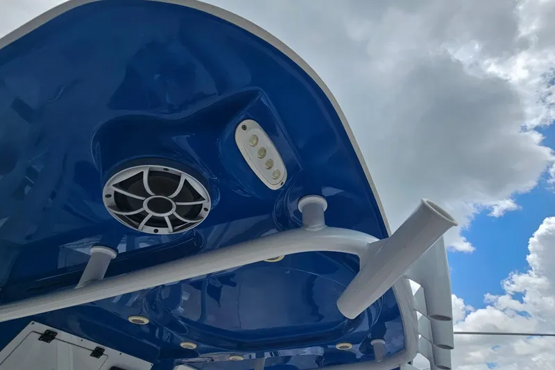 Slide: The Image of 2021 Sea Pro 259 Center Console boat with blue canopy and speaker system. - 24