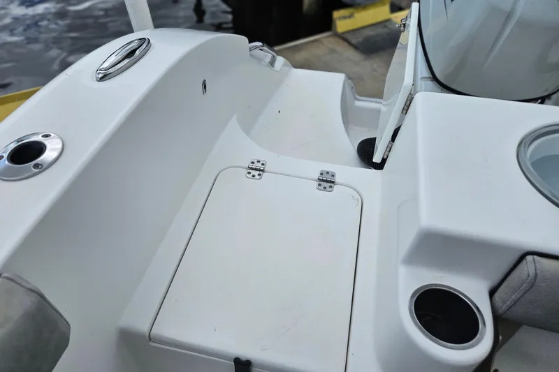 Slide: The Image of 2021 Sea Pro 259 Center Console boat interior with storage compartment and cup holder. - 27