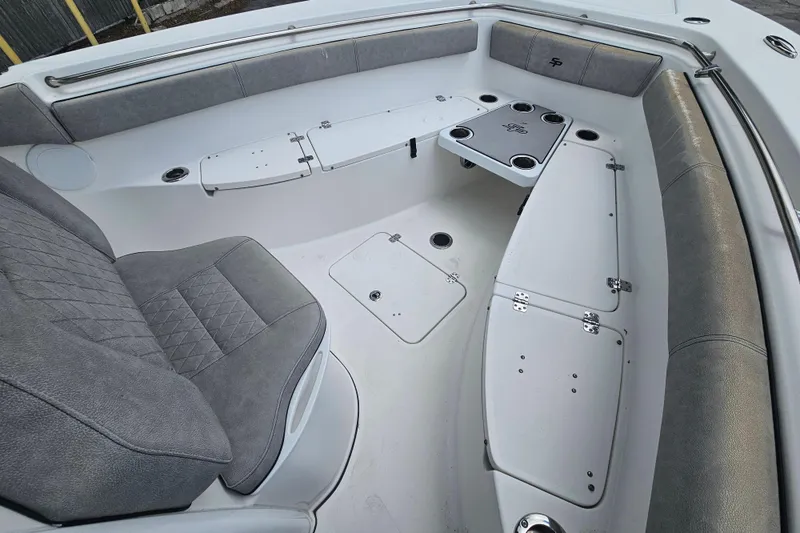 Slide: The Image of 2021 Sea Pro 259 Center Console boat interior with gray seating and storage compartments. - 28
