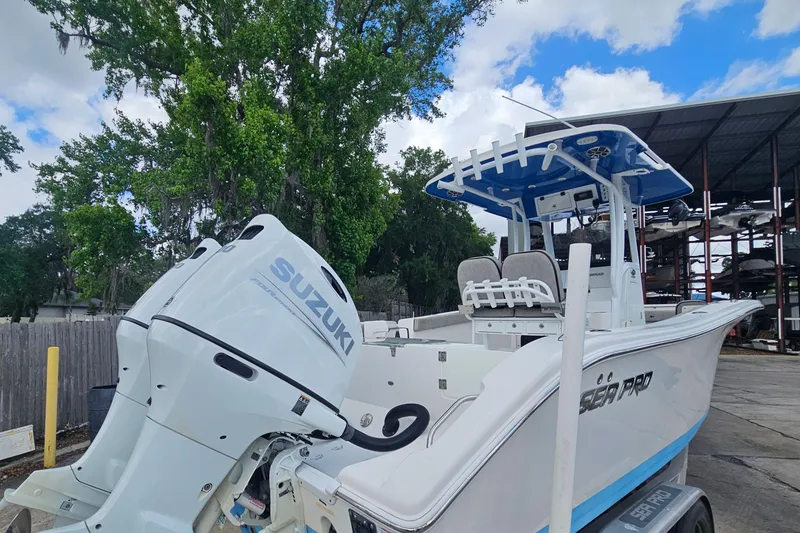 Slide: The Image of 2021 Sea Pro 259 Center Console boat with Suzuki engine, parked outdoors. - 3