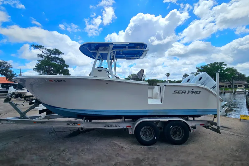 Slide: The Image of 2021 Sea Pro 259 Center Console boat on trailer under a bright blue sky. - 5