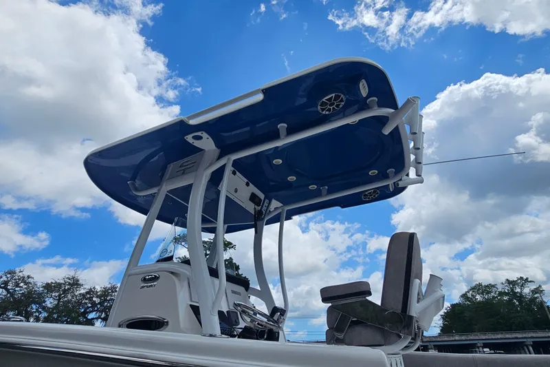 Slide: The Image of 2021 Sea Pro 259 Center Console boat against a bright blue sky with clouds. - 7