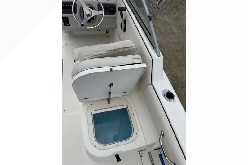Slide: The Image of 2007 Robalo R227 Dual Console boat interior with seat and storage compartment. - 10