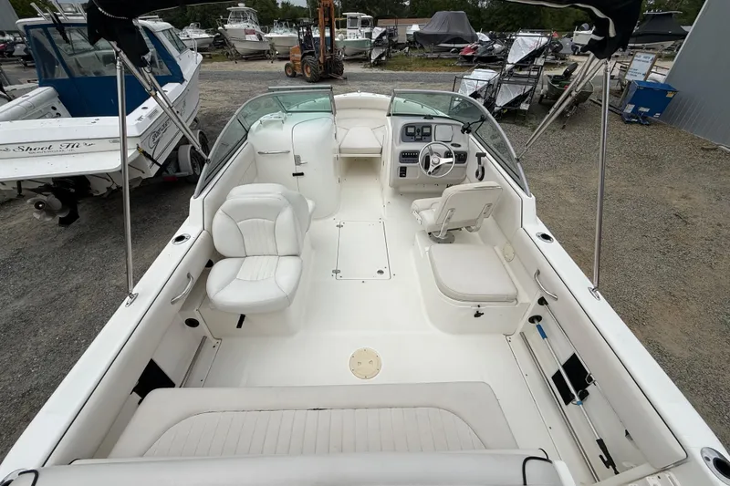 Slide: The Image of 2007 Robalo R227 Dual Console boat interior with white seating and steering console. - 13