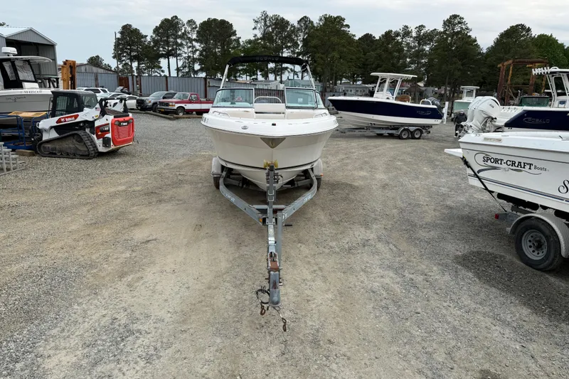 Slide: The Image of 2007 Robalo R227 Dual Console boat on trailer in a boatyard setting. - 21