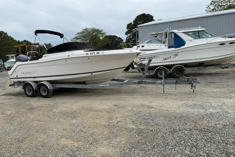 Slide: The Image of 2007 Robalo R227 Dual Console boat on trailer in outdoor storage area. - 5