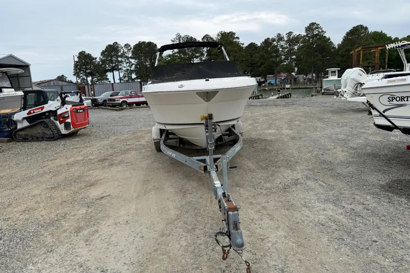Slide: The Image of 2007 Robalo R227 Dual Console boat on trailer in a marina setting. - 7
