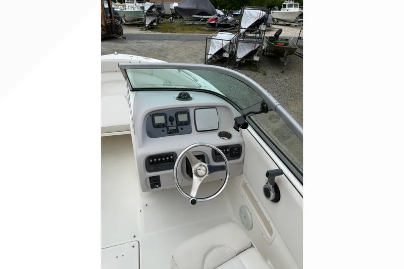Slide: The Image of 2007 Robalo R227 Dual Console boat dashboard with steering wheel and controls. - 9