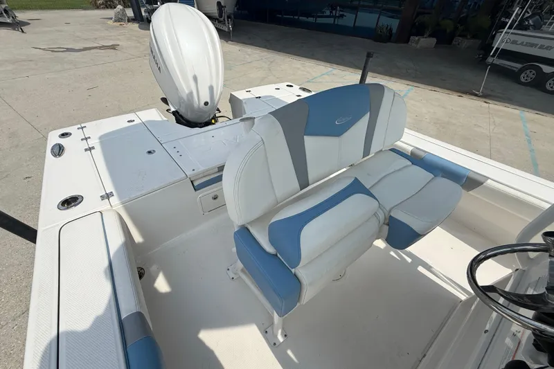 Slide: The Image of 2023 Robalo 246 Cayman boat interior with dual seating and outboard motor. - 11