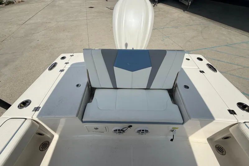 Slide: The Image of 2023 Robalo 246 Cayman boat interior with cushioned seating and storage compartments. - 12